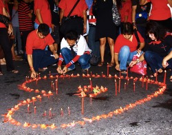 Thaialnd red-shirt pro-democracy supporters show the dead remain in their hearts